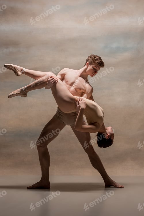 Preview: Couple of ballet dancers posing over gray background