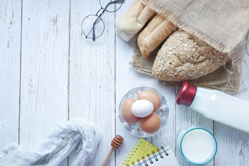 Preview: eggs in a bowl, whole meal bread and milk on table