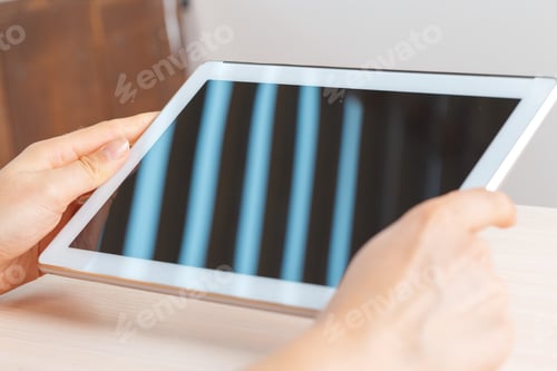 Preview: woman holding digital tablet, closeup