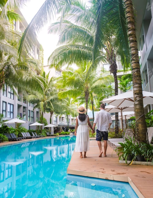 Preview: Men and women with hat walking by the pool during vacation