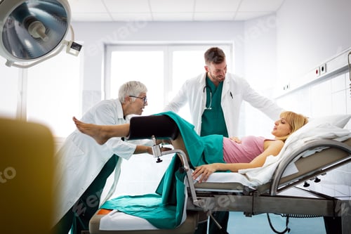 Preview: Obstetricians assisting in the hospital woman in labor pushes to give birth