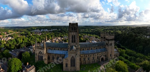 Preview: Aerial panoramic view of Durham Cathedral surrounded by lush green vegetation in Durham, England