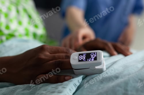 Preview: Close up of oximeter on african american girl hand