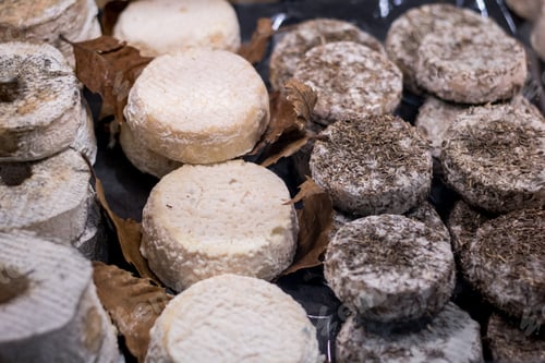Preview: View on a lot of blue cheese and camembert on a showcase in a French shop.