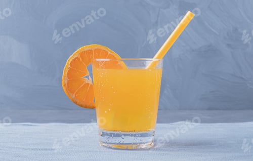 Preview: Close up photo of Freshly made orange juice on grey background