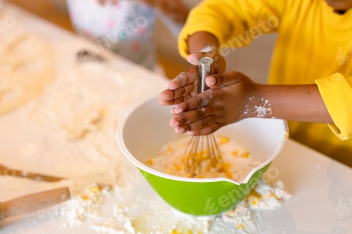 Preview: Hands of african american boy baking, mixing dough