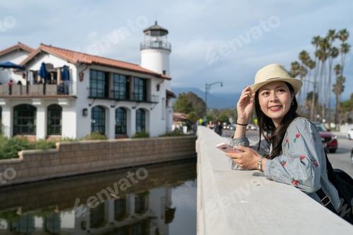 Preview: female leaning on railing near lighthouse