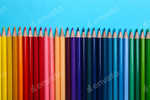 Preview: Colorful pencils on light blue background, flat lay