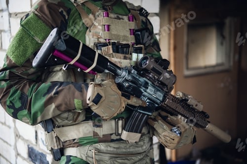 Preview: Brutal military man is sitting and cleaning and preparing his gun to the battle
