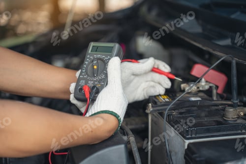 Preview: Close-up of Car mechanic noting repair parts during open car hood engine repair