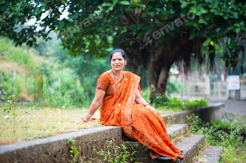 Preview: Happy Indian woman in traditional clothes at outdoor.