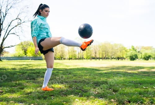 Preview: Young woman practicing soccer skills with ball.