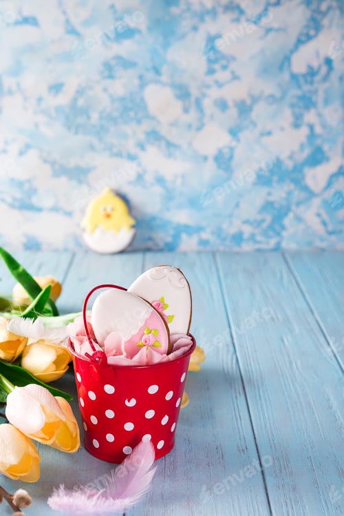 Preview: Happy Easter gingerbread cookie eggs with bucket on blue wood background,