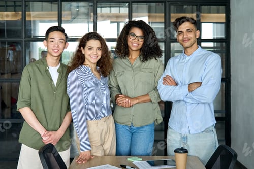 Preview: Young multiracial business people team standing in office. Group portrait