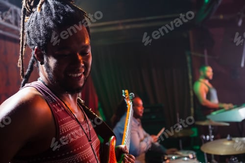 Preview: Band Playing Music on Stage at Night