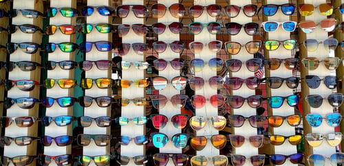 Preview: All in a row bright and colorful shades in outdoor retail display for retail sale fashion.