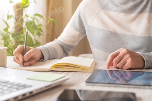 Preview: Organized woman managing daily tasks, setting goals, and planning work schedule at home office