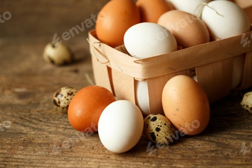 Preview: Chicken and quail eggs on a wooden rustic background