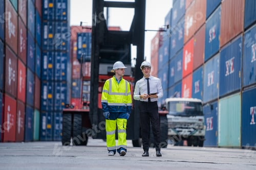 Preview: Businesspeople with Cargo container worker check goods and stock in industrial container terminal.