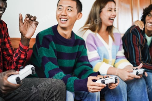 Preview: Multiracial young friends having fun playing video games at home