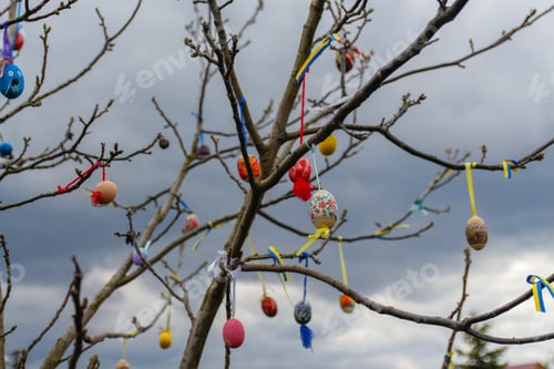 Preview: Many Easter eggs decorated outdoor. Handmade diy home exterior decoration with colorful easter eggs