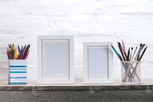 Preview: close up view of photo frames and office supplies at workplace