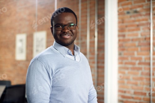 Preview: Portrait of smiling African American businessman at corporate office.