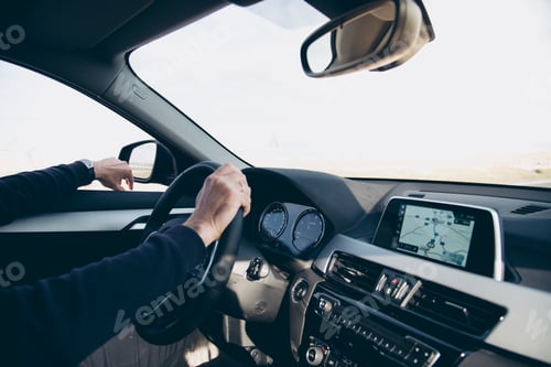 Preview: Side view of man driving car with navigation GPS