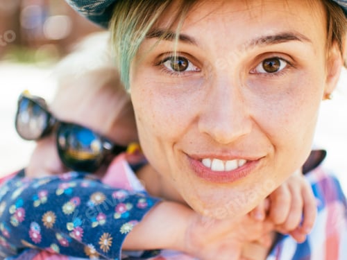 Preview: Smiling Woman Posing with a Young Child