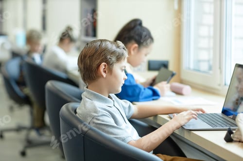 Preview: Boy using Laptop in School in It Class For Children