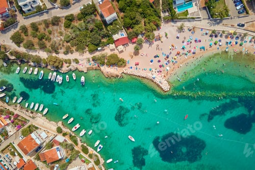 Preview: Coastal village with red-roofed houses, turquoise waters and boats along shore