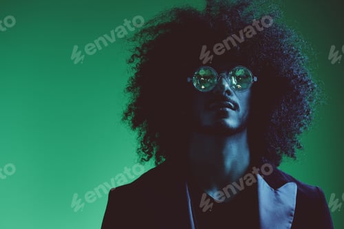 Preview: Fashion portrait of a man with curly hair on a green background with sunglasses, multinational