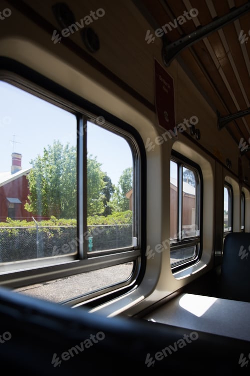 Vista previa: Interior of train carriage looking out a window casting shadows