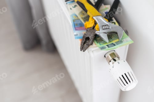 Preview: A stack of money on the background of the radiator. Expensive utilities.