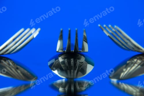 Preview: front close view metal forks on blue background cutlery kitchen food color photo table dinner