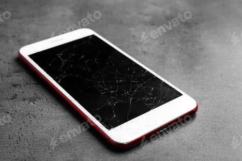 Preview: Modern smartphone with broken display on table. Device repair service
