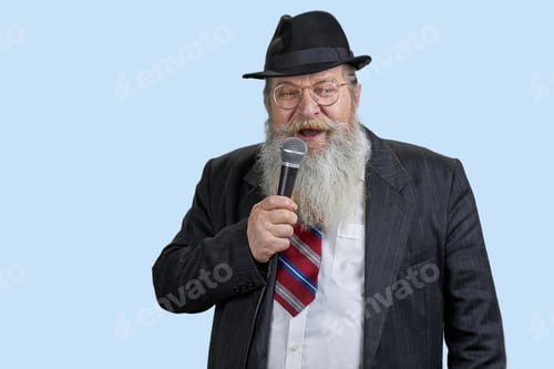 Preview: Portrait of excited aged man with microphone.