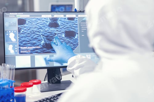 Preview: Medical researcher analysing evolution of coronavirus pointing at screen