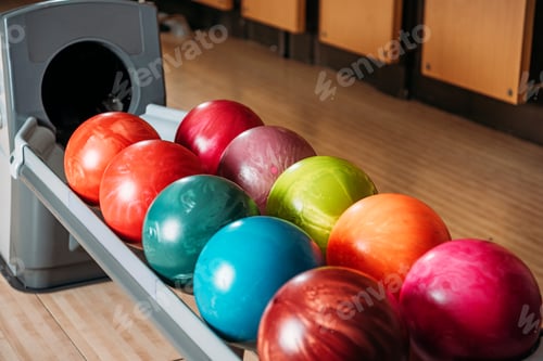 Preview: close-up shot of stand with colorful bowling balls in club
