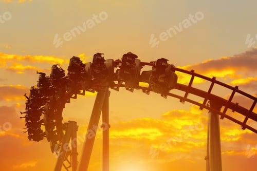 Preview: Roller coaster in the amusement park with the sunset background.