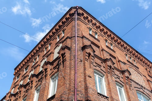 Preview: An old large brick building with a white sign for the name of a cafe