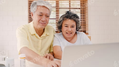 Preview: Asian elderly couple using laptop conference with doctor about medicine information
