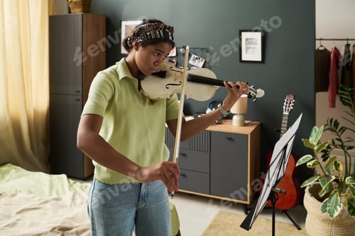 Preview: Practicing Violin in Cozy Bedroom Setting with Sheet Music
