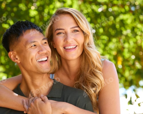 Vista previa: Close Up Portrait Of Loving Multi-Racial Couple Or Friends Hugging Outdoors In Countryside Together