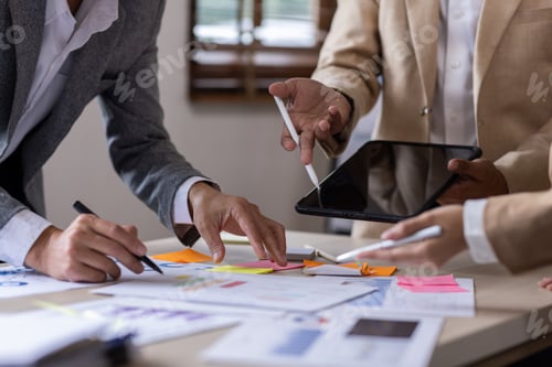 Preview: Group of confident business people point to graphs and charts to analyze market data, balance sheet,