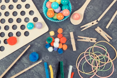 Preview: Colorful pompoms, balls and rubber erasers with spoon and tongs