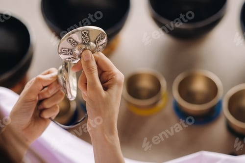 Preview: Close-up of a Tibetan singing bowl in your hands - Translation of mantras: transform your impure