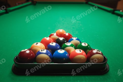 Preview: Two cues and pyramid on a billiard table.