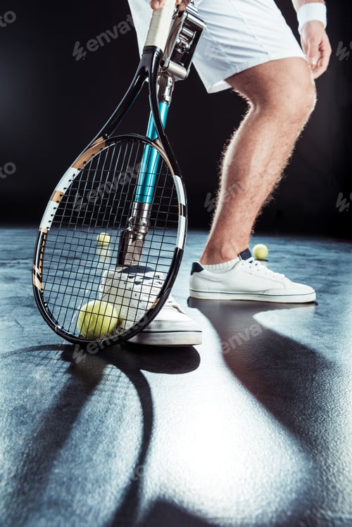 Preview: partial view of paralympic tennis player with tennis racket and ball
