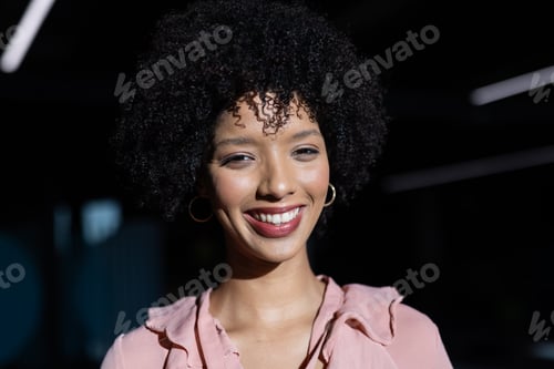 Preview: Smiling woman in business attire posing confidently in office environment